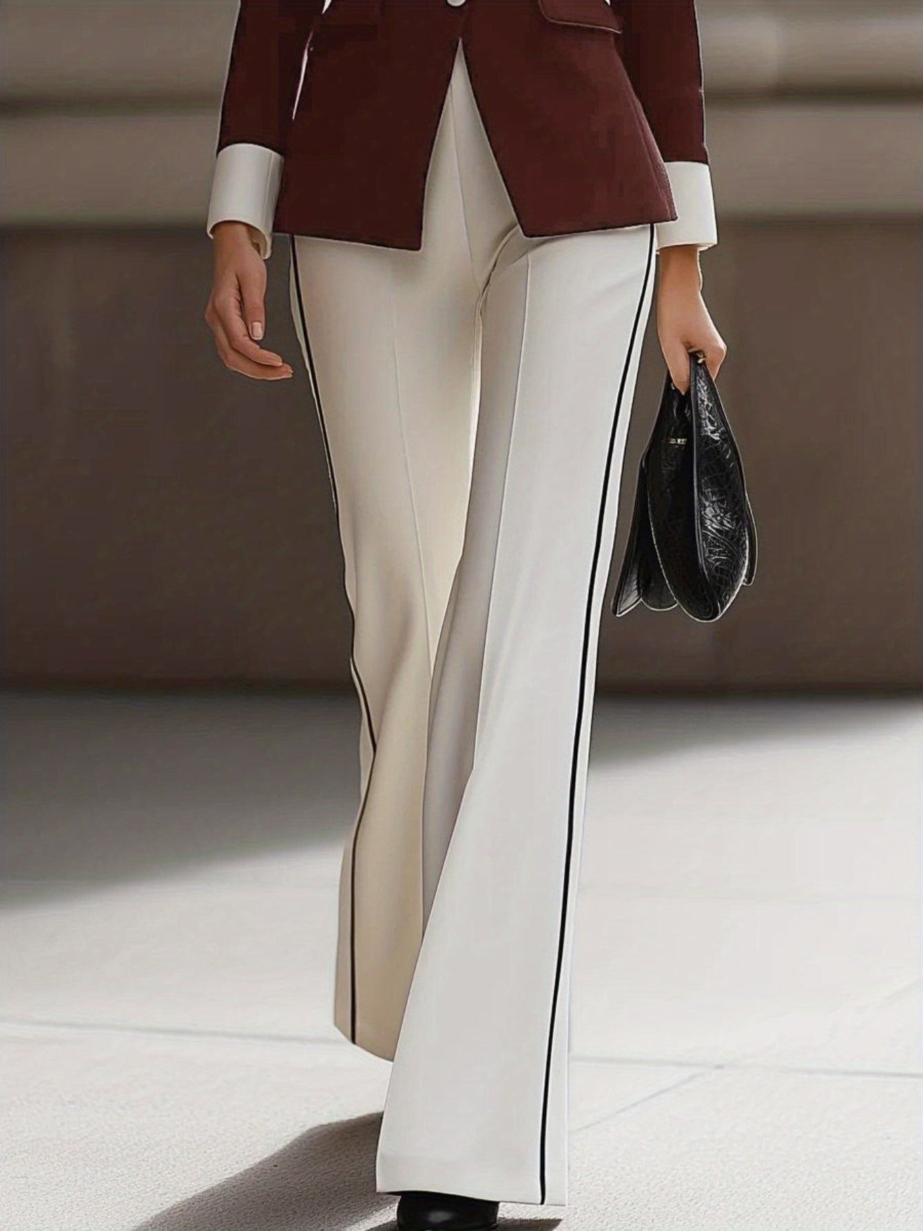 Sophisticated Black And White Suit Ensemble for Fall And Winter, Featuring a Blazer with a Contrasting Collar And Flared Pants, Ideal for Professional Gatherings.